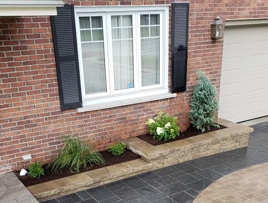 Brick house with landscaped garden and driveway