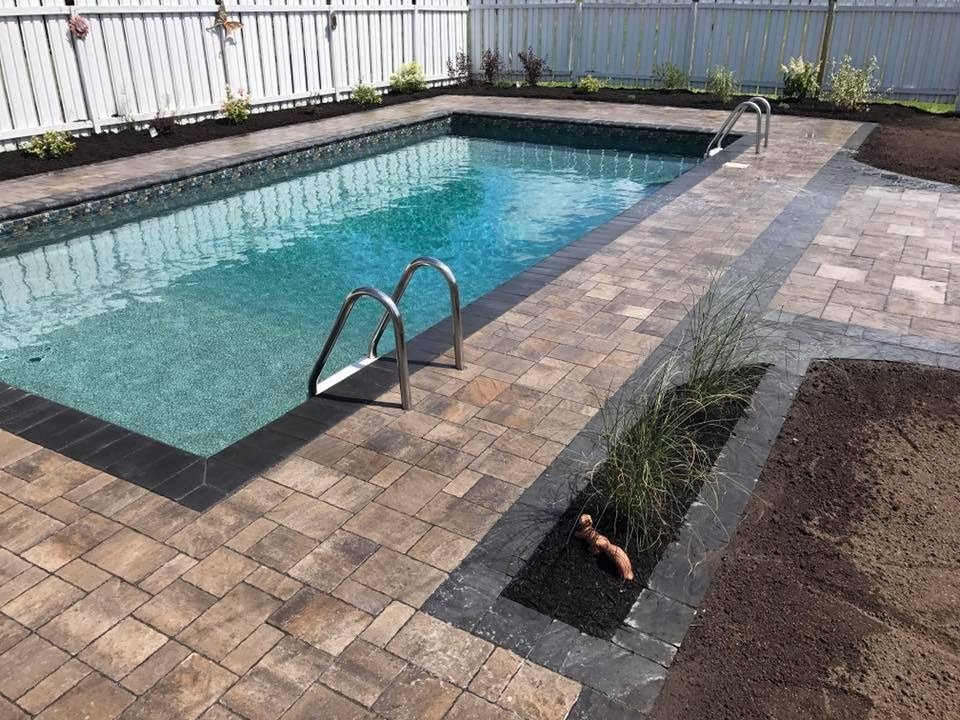 Backyard swimming pool with paver patio.