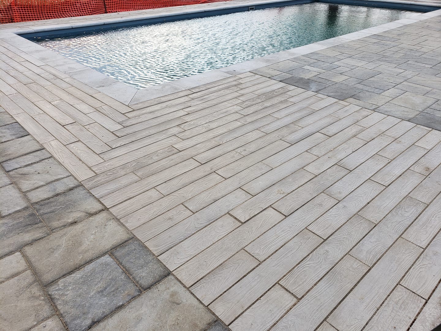 Modern outdoor pool with stylish tile flooring.