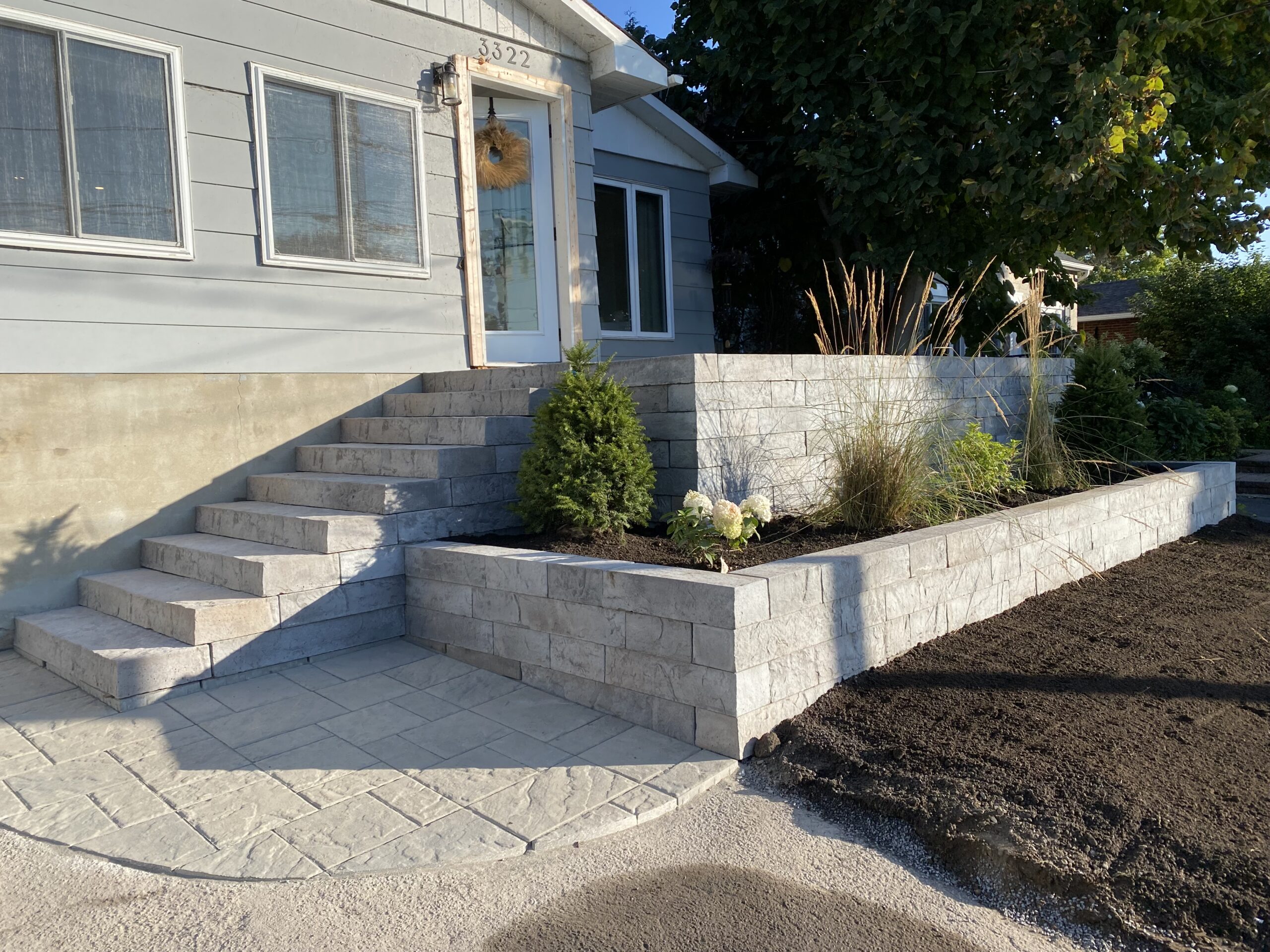 House with stone steps and garden wall landscaping.