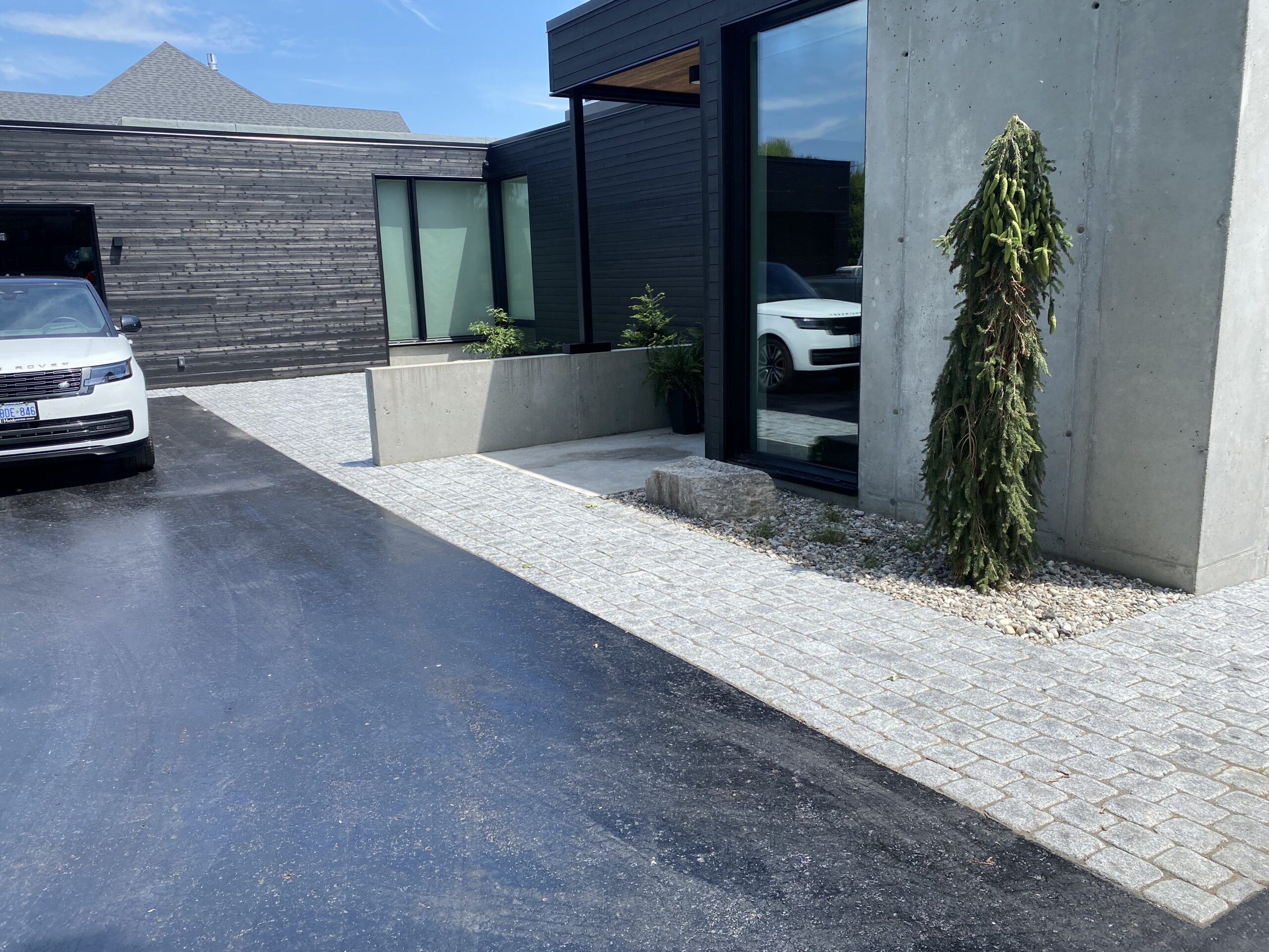 Modern house driveway with car.