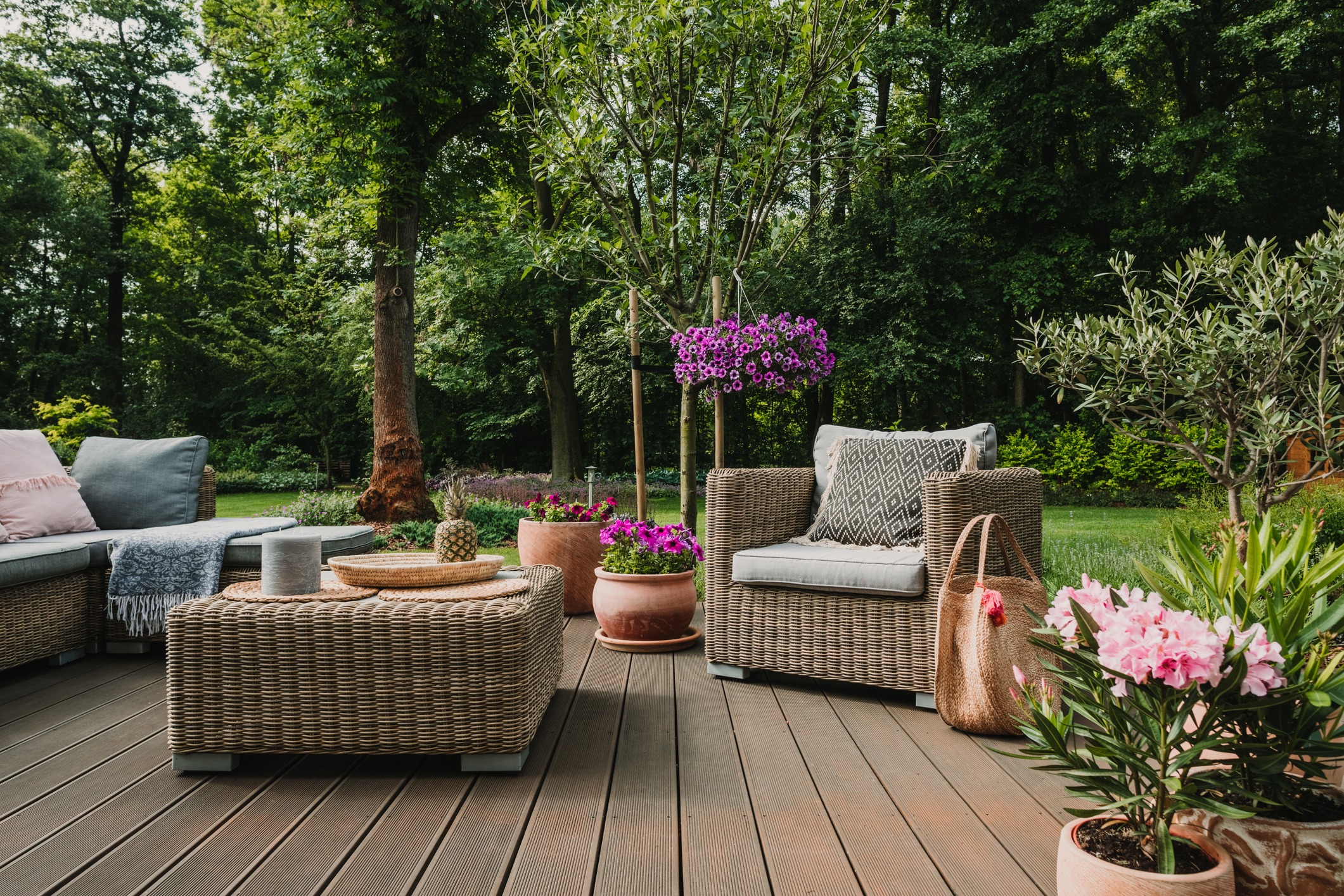 Cozy outdoor patio with wicker furniture and flowers