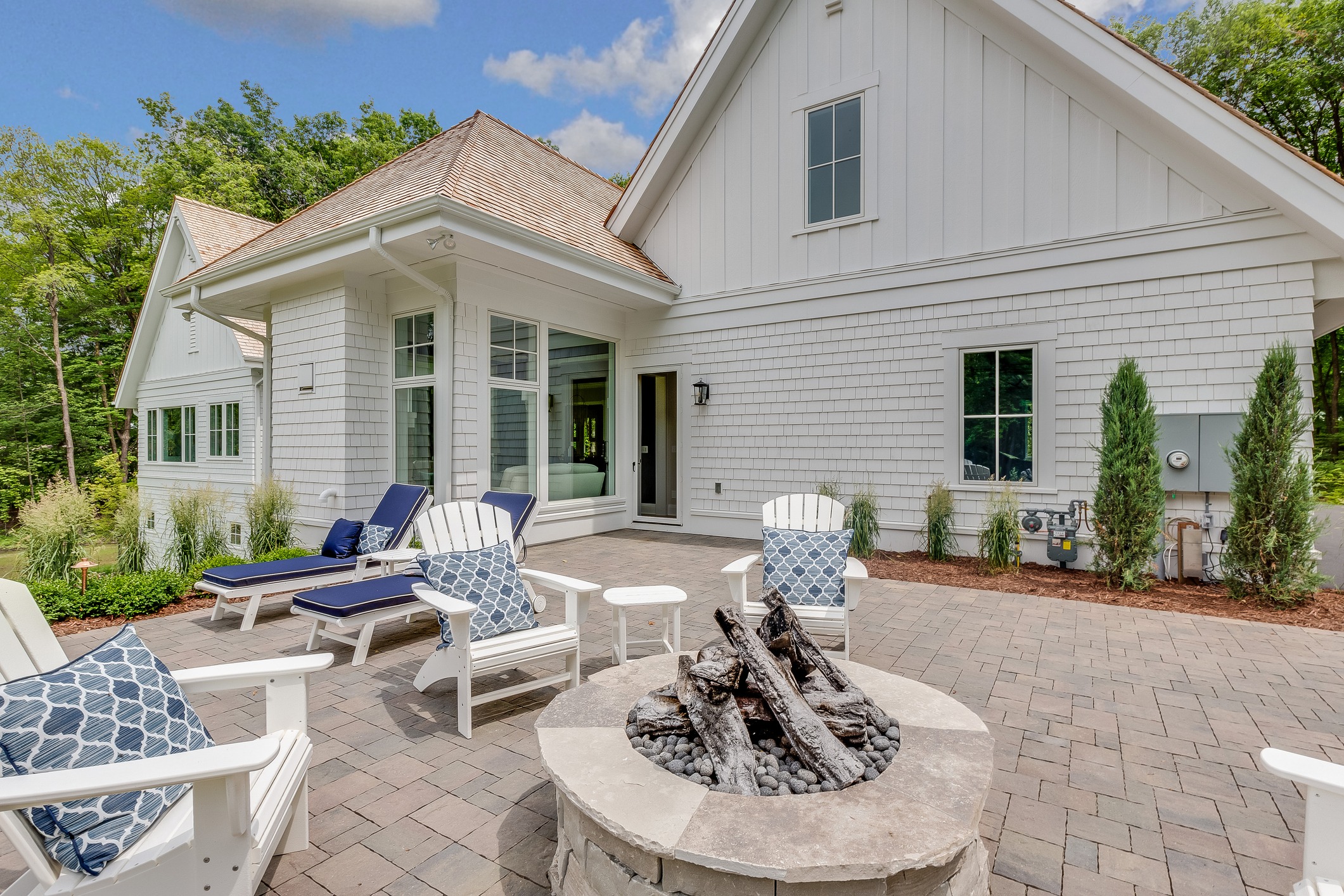 Patio with chairs and fire pit.
