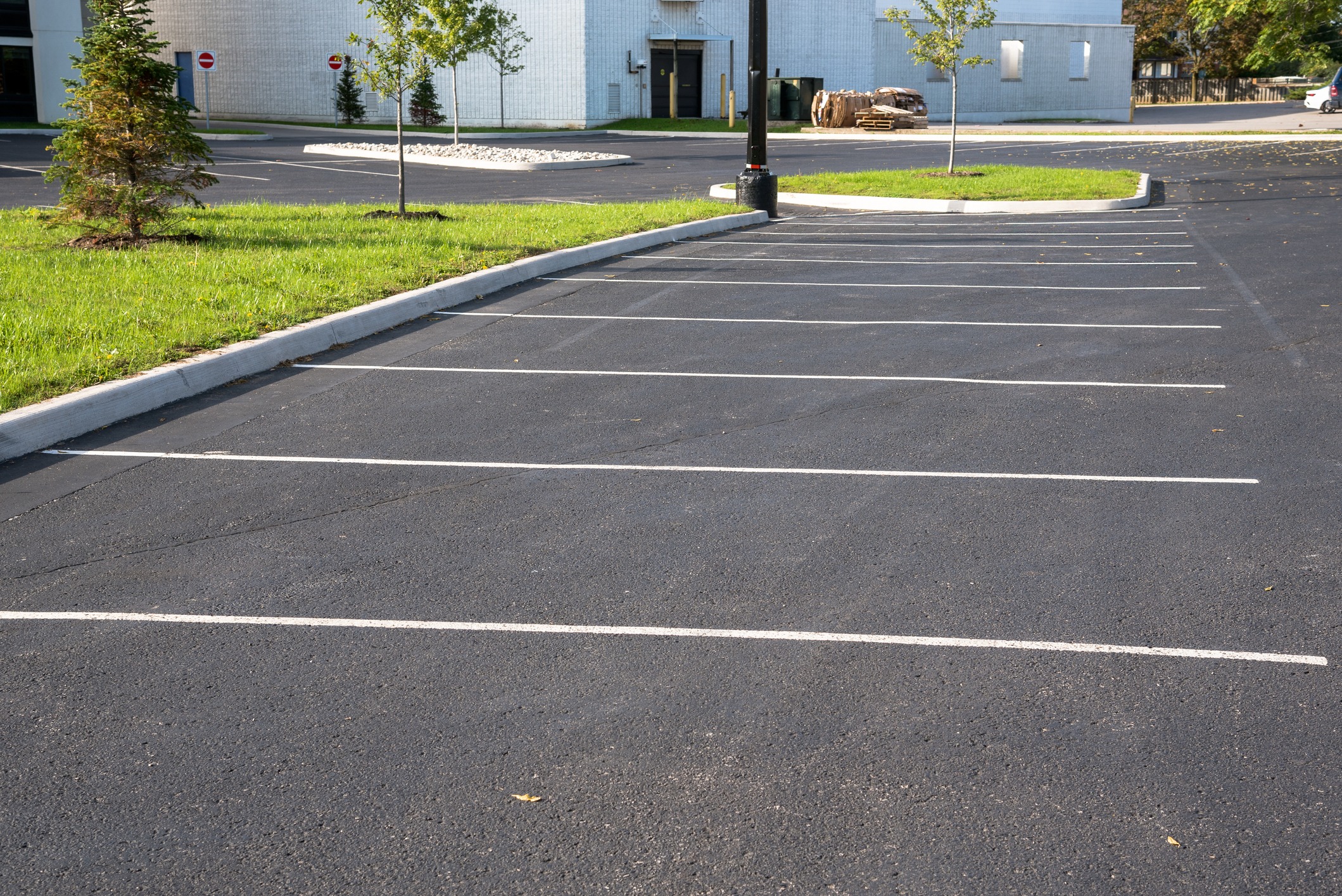Empty parking lot with green grass edging