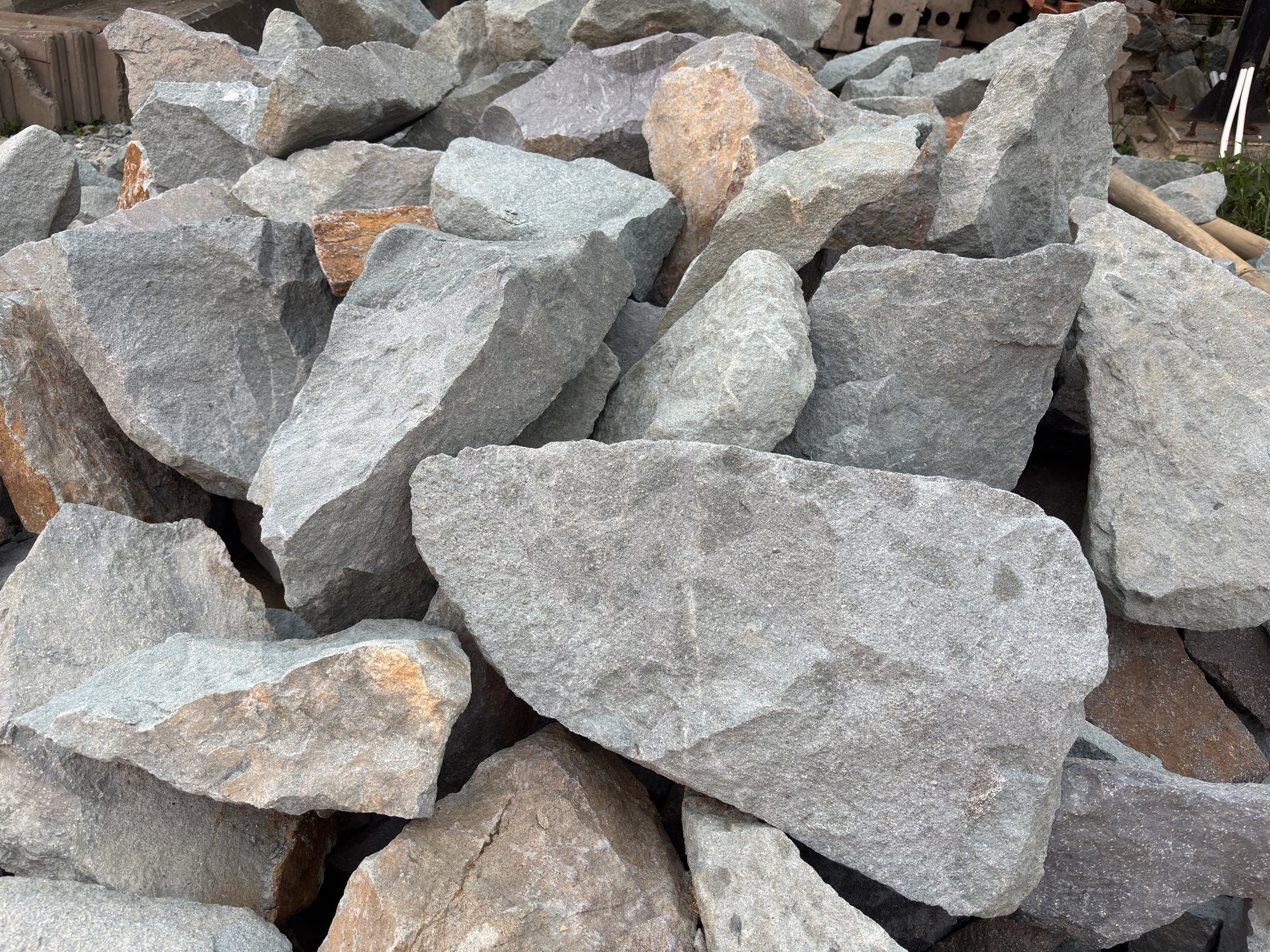 Pile of large gray and brown rocks.