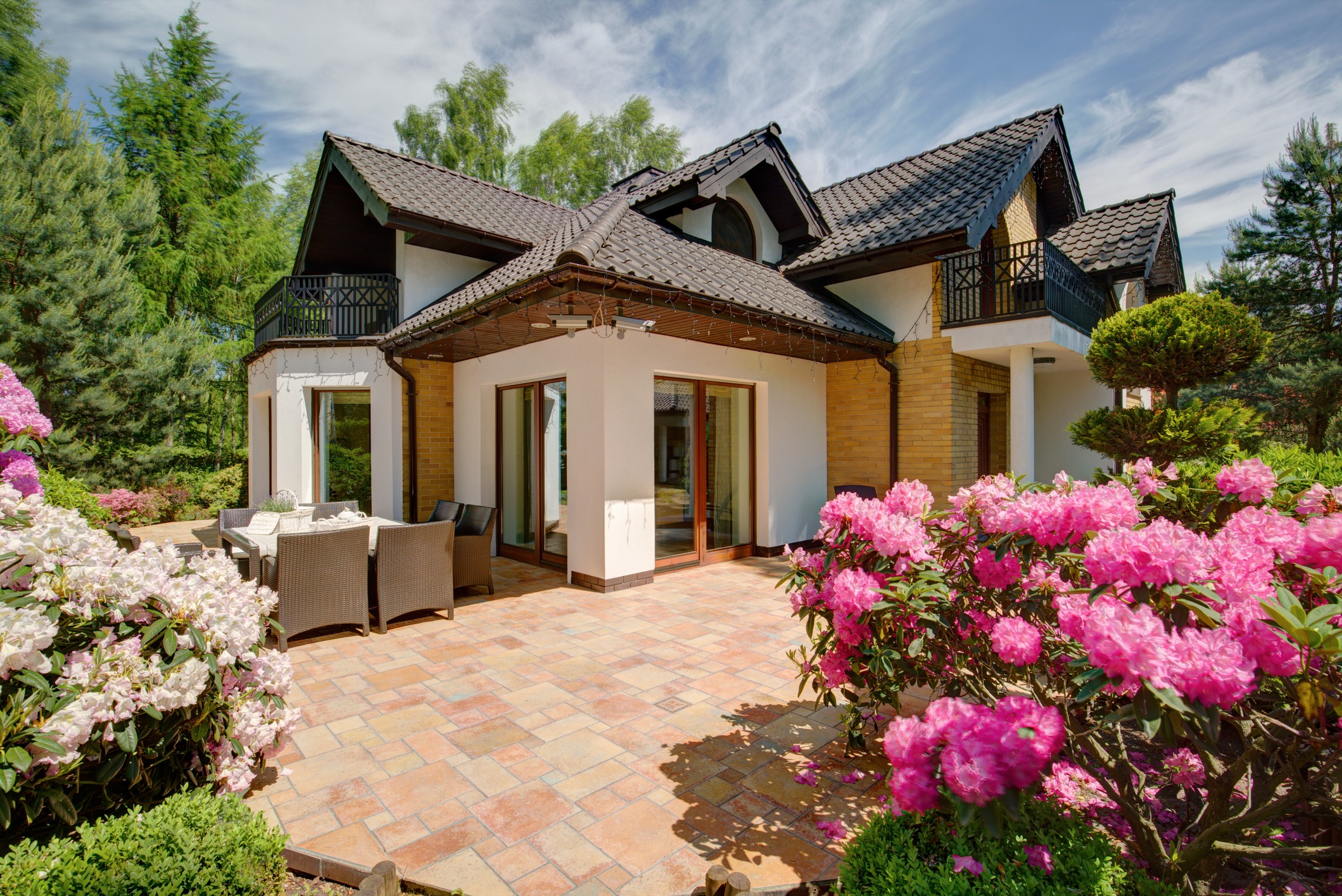 Charming house with garden and blooming flowers.