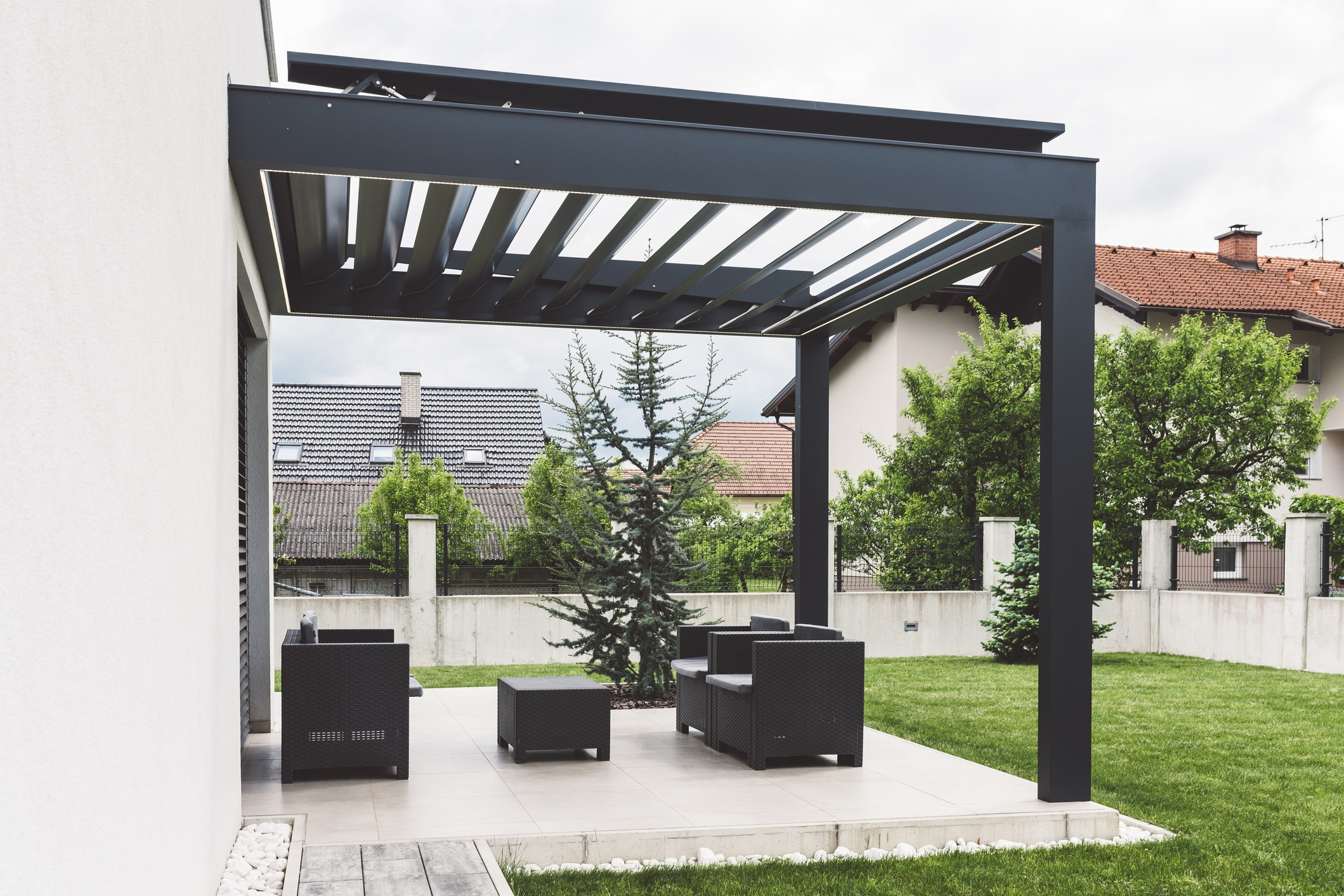 Modern patio with covered pergola and outdoor seating.